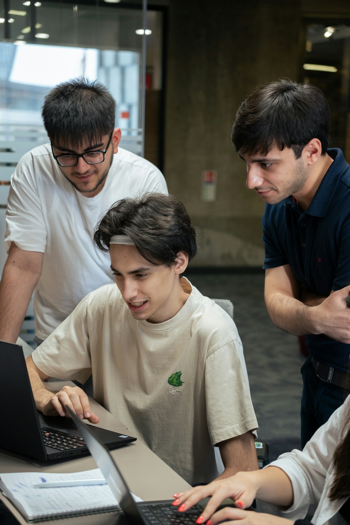 Developers discussing their work together around a laptop